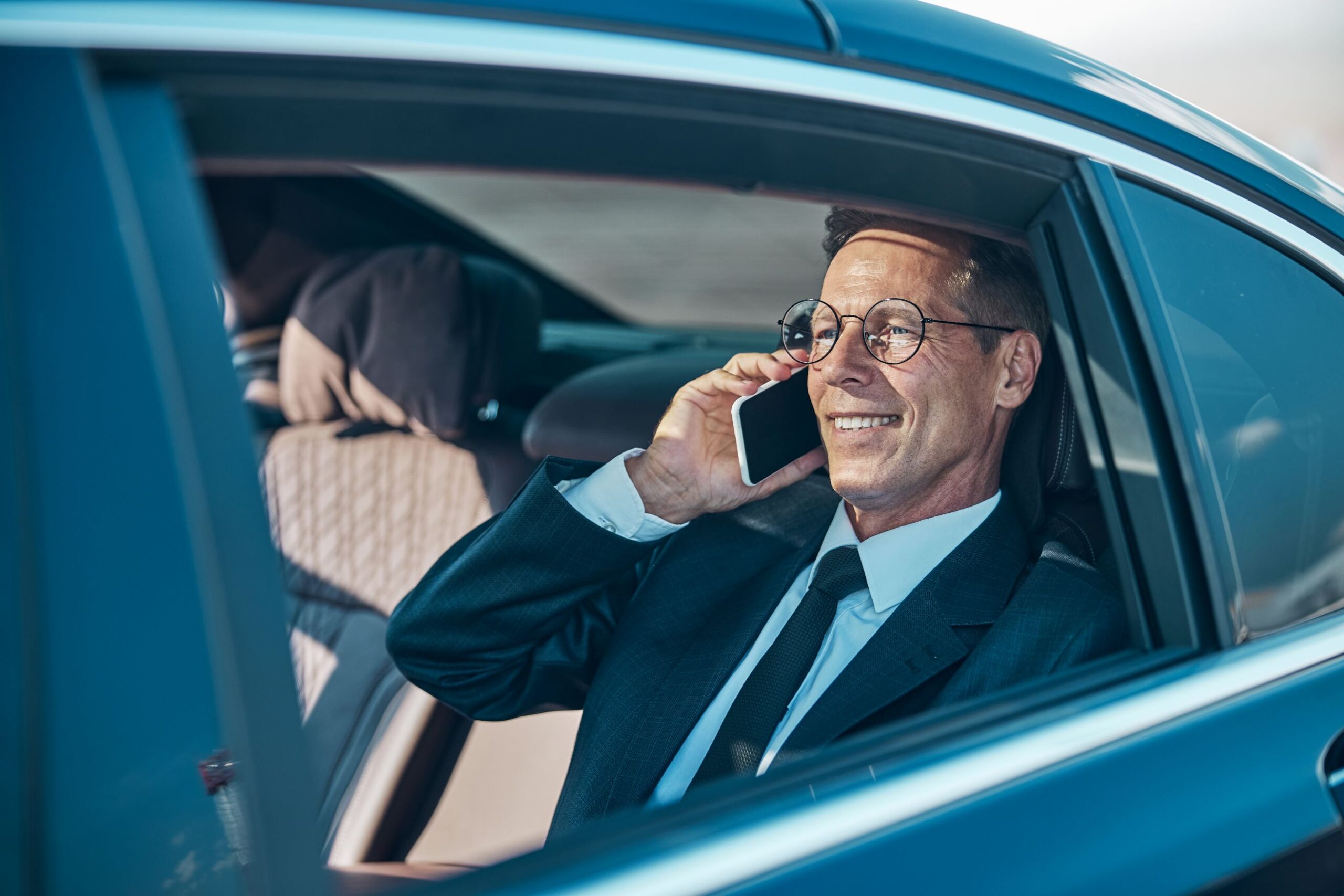 cheerful-businessman-talking-on-smartphone-during-2021-09-03-21-03-30-utc